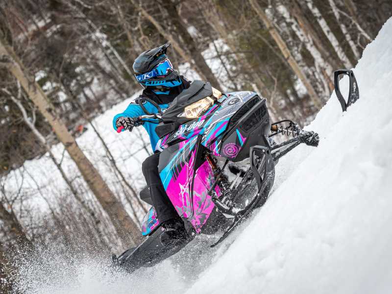 Snowmobiler racing on a snowy hill during competition in Michigan, Wisconsin, Minnesota, Iowa